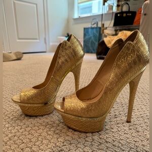 Gold BeBe platform pumps.